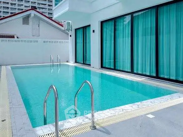 Luxurious private pool area with modern design and elegant glass doors.