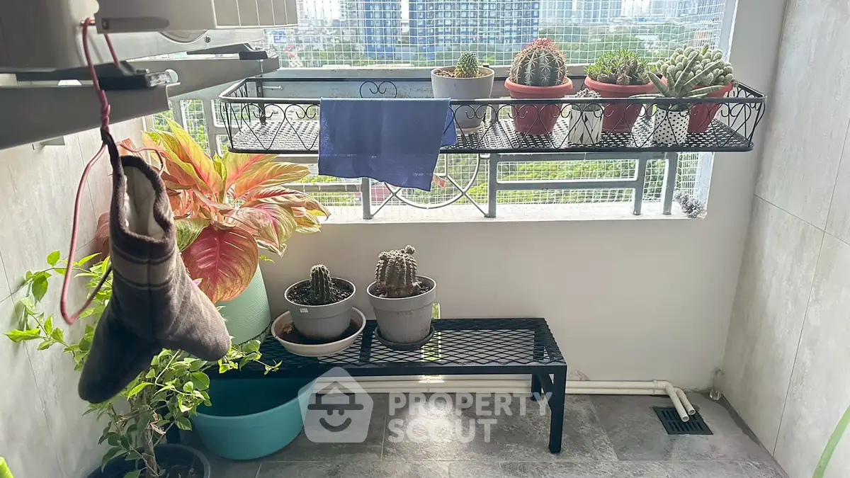 Charming balcony with potted plants and city view, perfect for relaxation and urban gardening.