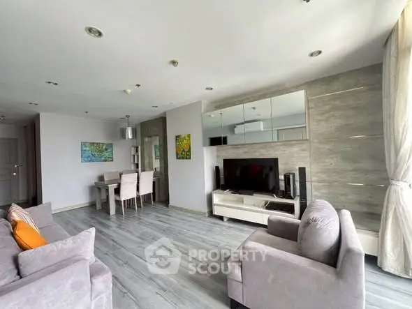 Spacious modern living room with stylish decor and large windows for natural light.