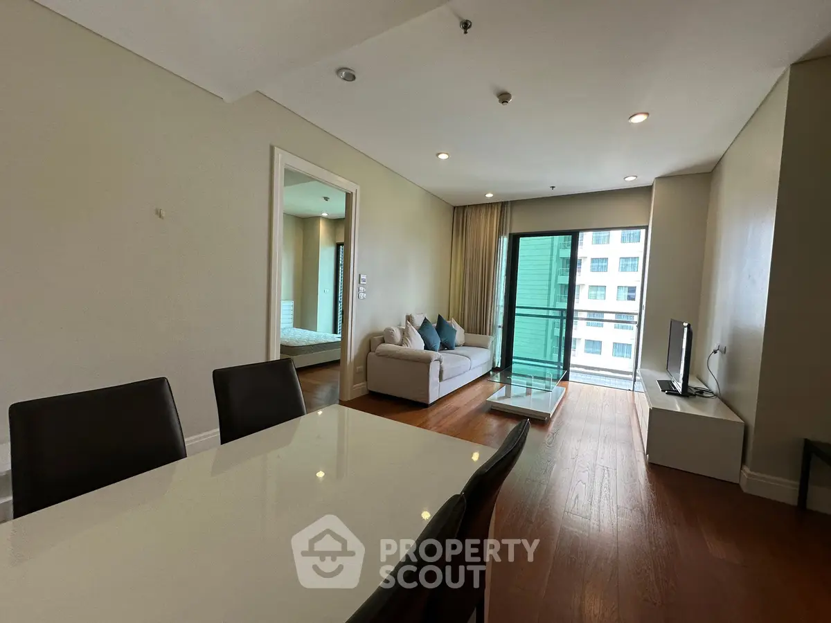 Modern living room with sleek furniture and balcony view in urban apartment