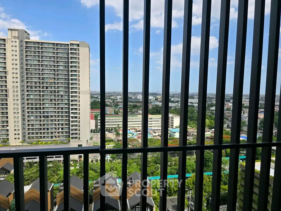 Stunning high-rise apartment view with expansive cityscape and lush greenery.
