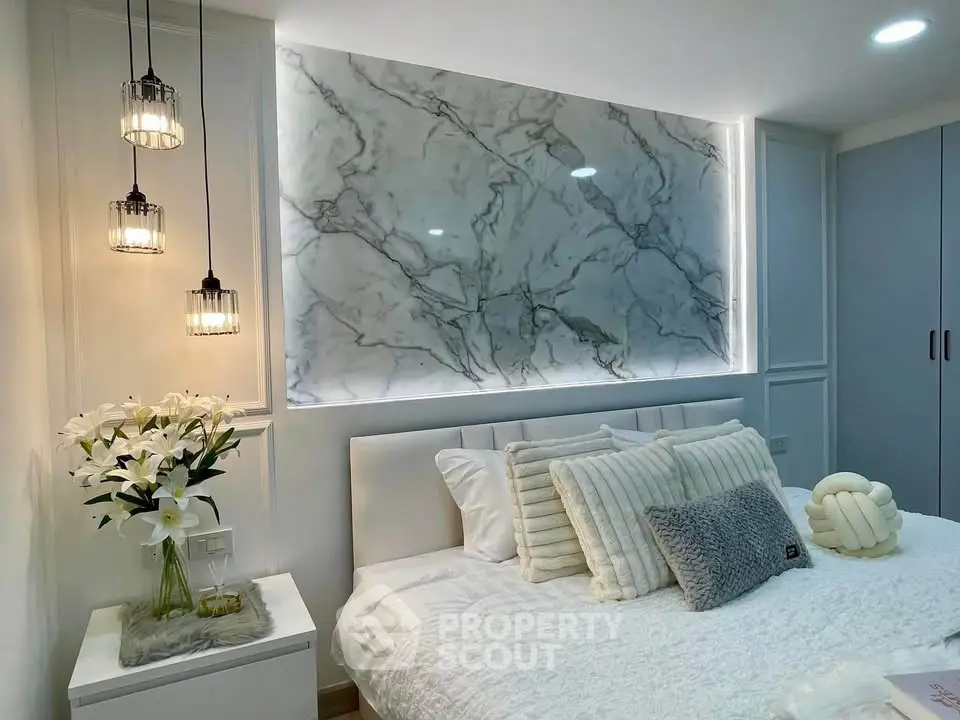 Luxurious bedroom with elegant marble accent wall and cozy lighting