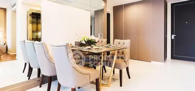 Elegant dining area with plush chairs and mirrored wall in modern apartment
