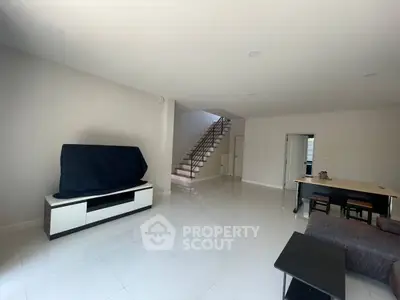 Spacious modern living room with sleek white tiles and minimalist decor