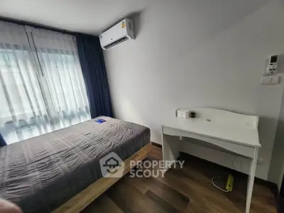 Cozy bedroom with modern air conditioning and stylish wooden flooring