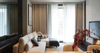 Modern living room with stylish decor and large windows for natural light.