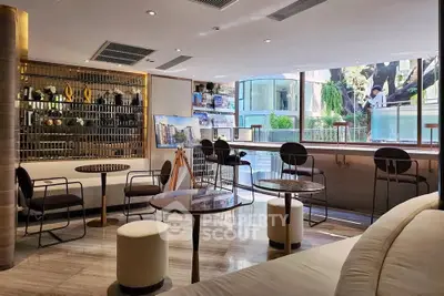Modern living room with stylish furniture and large windows offering a scenic view.