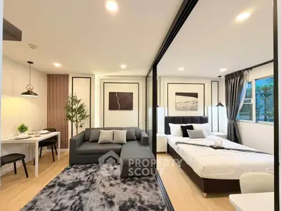 Modern open-plan living room and bedroom with stylish decor and natural light.