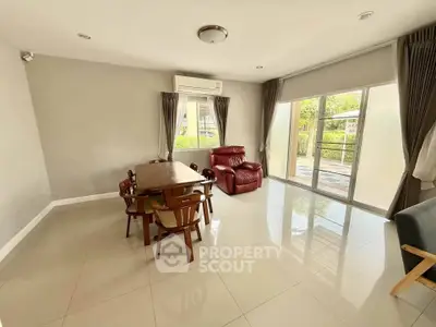 Spacious living room with modern furniture and large windows for natural light.