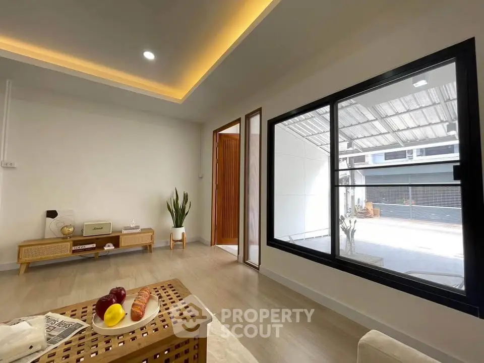 Modern living room with large window and stylish decor