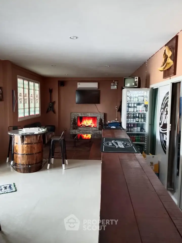 Cozy living room with fireplace and bar area, perfect for entertaining guests.