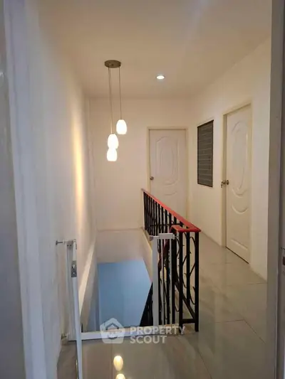 Modern hallway with stylish lighting and sleek railing design