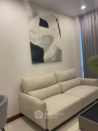 Modern living room with stylish sofa and abstract wall art, perfect for contemporary urban living.
