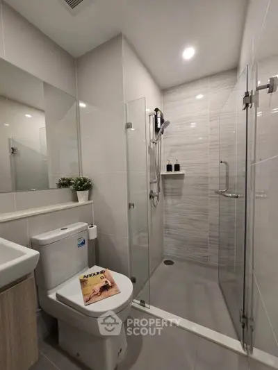 Modern bathroom with glass shower enclosure and sleek fixtures