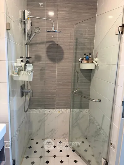 Modern bathroom with glass shower enclosure and stylish tile design