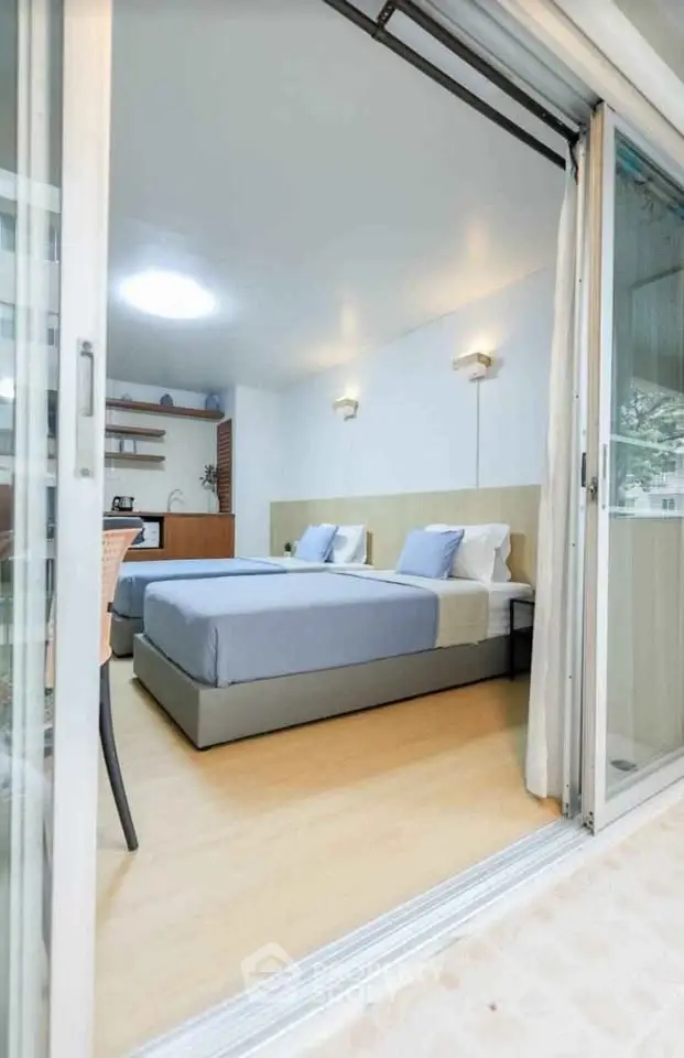 Modern bedroom with sliding glass doors and stylish decor