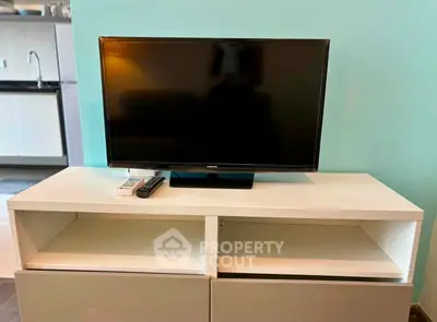 Modern living room with sleek TV setup and stylish cabinetry