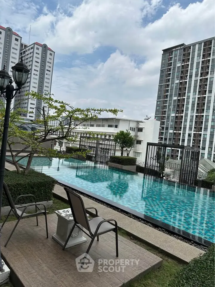 Luxurious rooftop pool with stunning city views in modern high-rise building.