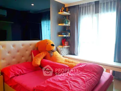 Cozy bedroom with plush teddy bear and vibrant pink bedding, featuring natural light and stylish decor.