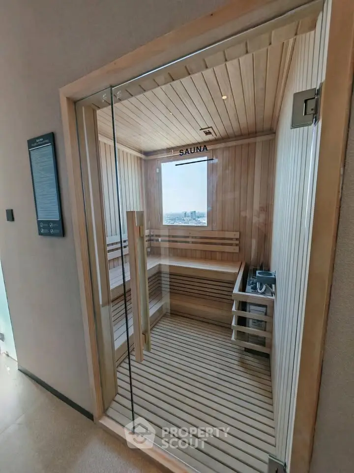Luxurious sauna room with panoramic city view, perfect for relaxation and wellness in a modern building.