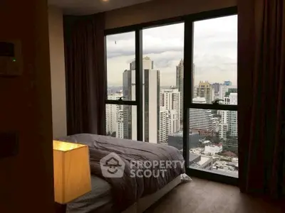 Luxurious bedroom with stunning city view from floor-to-ceiling windows.