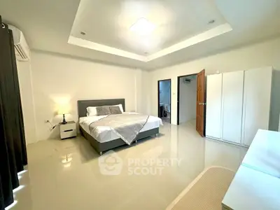 Spacious modern bedroom with sleek design and ample natural light