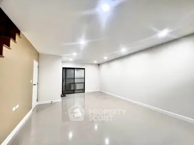 Spacious modern living room with sleek tile flooring and recessed lighting
