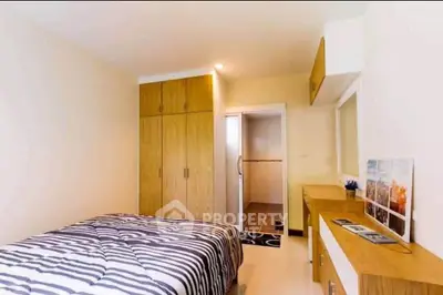 Cozy bedroom with modern decor and ample storage space in a stylish apartment.