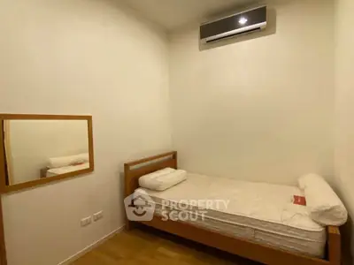 Cozy minimalist bedroom with single bed and air conditioning
