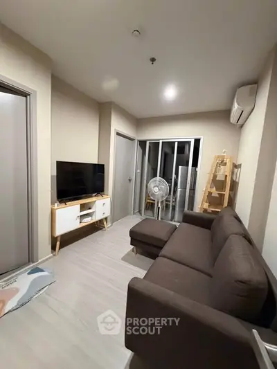 Modern living room with sleek furniture and neutral tones, perfect for cozy relaxation.