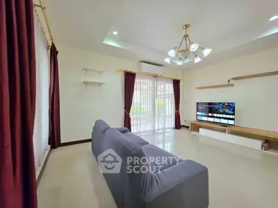 Spacious living room with modern decor and large windows for natural light.