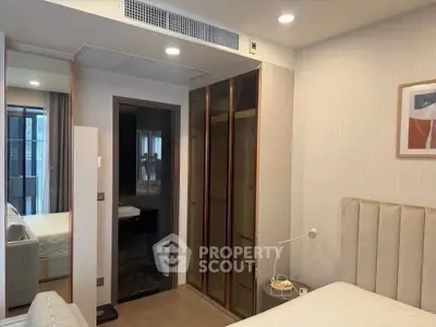 Modern bedroom with ensuite bathroom and stylish decor in a contemporary apartment.