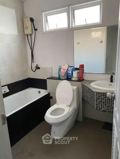 Modern bathroom with bathtub and sleek fixtures, ideal for comfortable living.