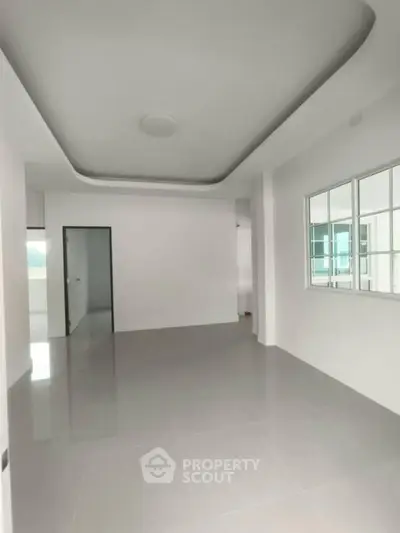Spacious modern living room with sleek design and large windows for natural light.
