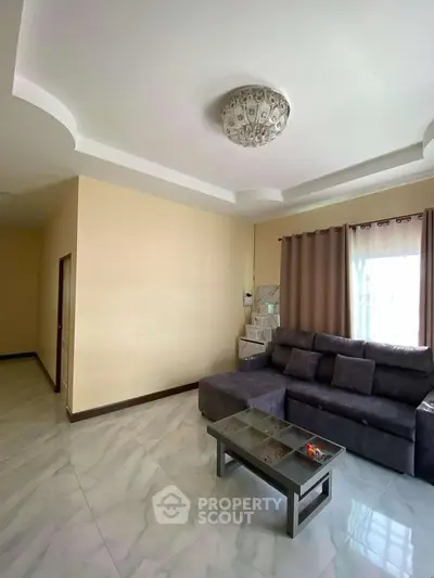 Spacious living room with modern sofa and elegant ceiling light