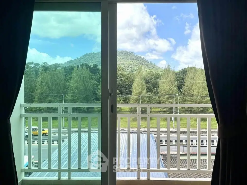 Stunning balcony view with lush greenery and mountain backdrop