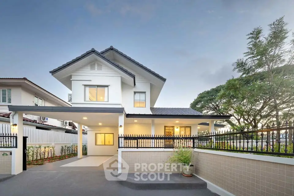 Stunning modern two-story house with spacious driveway and lush greenery, perfect for family living.