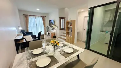 Modern open-plan living and dining area with stylish decor and natural light.