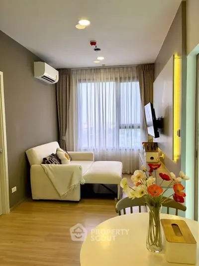 Cozy modern living room with large window and stylish decor