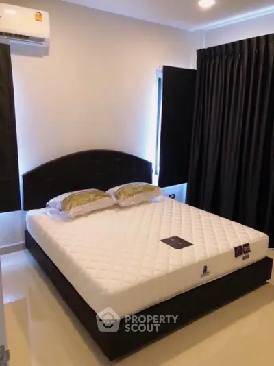 Modern bedroom with elegant black curtains and comfortable bed