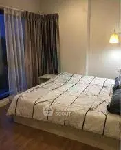 Cozy bedroom with modern decor and large window for natural light.
