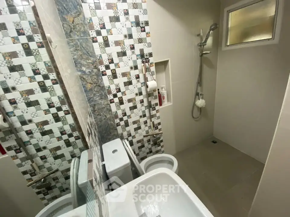 Modern bathroom with stylish tile design and shower area