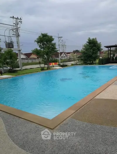 Luxurious outdoor swimming pool with serene surroundings and modern design, perfect for relaxation and leisure.