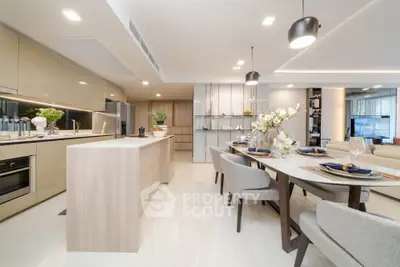 Luxurious open-plan kitchen and dining area with modern decor and elegant lighting.