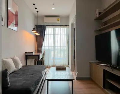 Modern living room with stylish decor and large window for natural light.