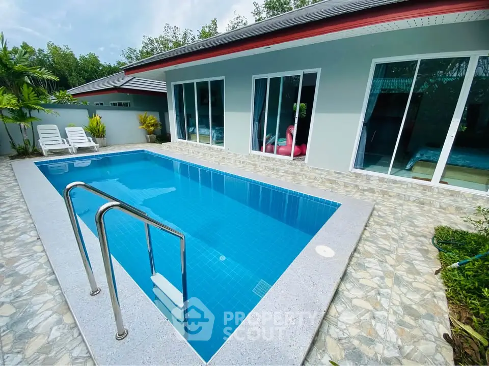 Stunning private pool area with modern design and lush greenery, perfect for relaxation and entertainment.