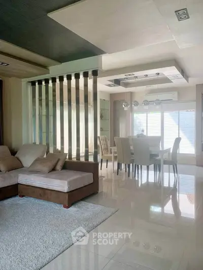 Luxurious modern living room with elegant dining area and plush seating