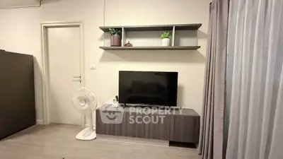 Modern living room with sleek TV stand and wall shelf, featuring minimalist decor and neutral tones.