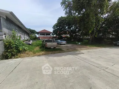 Spacious residential property with ample parking and lush greenery
