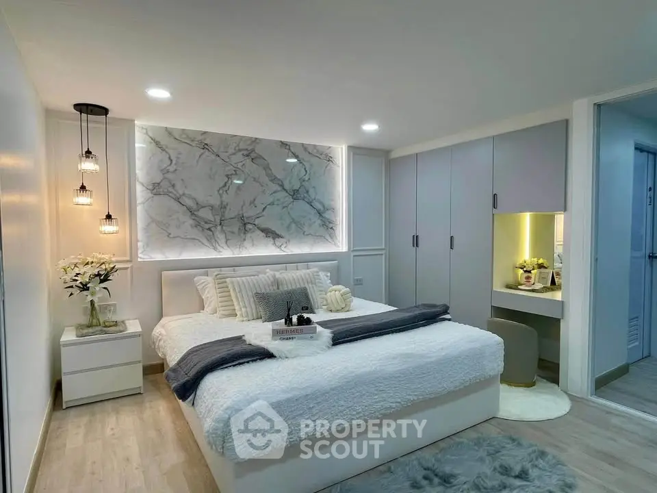 Luxurious bedroom with modern decor, elegant lighting, and cozy ambiance for ultimate relaxation.